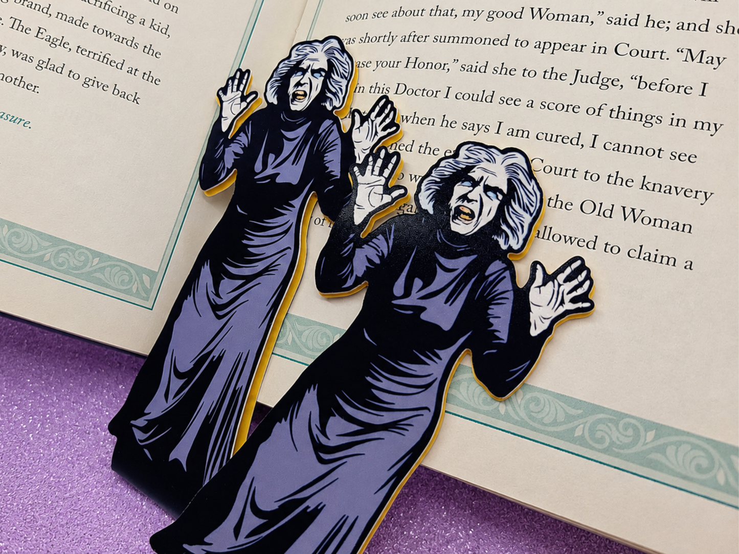 Close-up shots of magnetic bookmarks featuring original art of the creepy old woman from the classic horror movie House on Haunted Hill. The spooky vintage movie art is printed on high-quality coverstock.