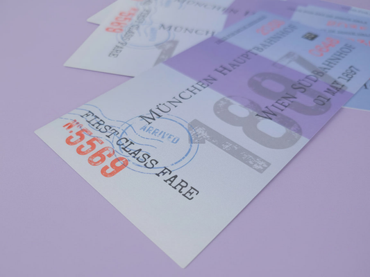 A close-up shot of a thick, double-sided Jonathan Harker train ticket bookmark from Dracula, showing realistic 19th-century vintage typography printed on ultra-heavy cardstock.