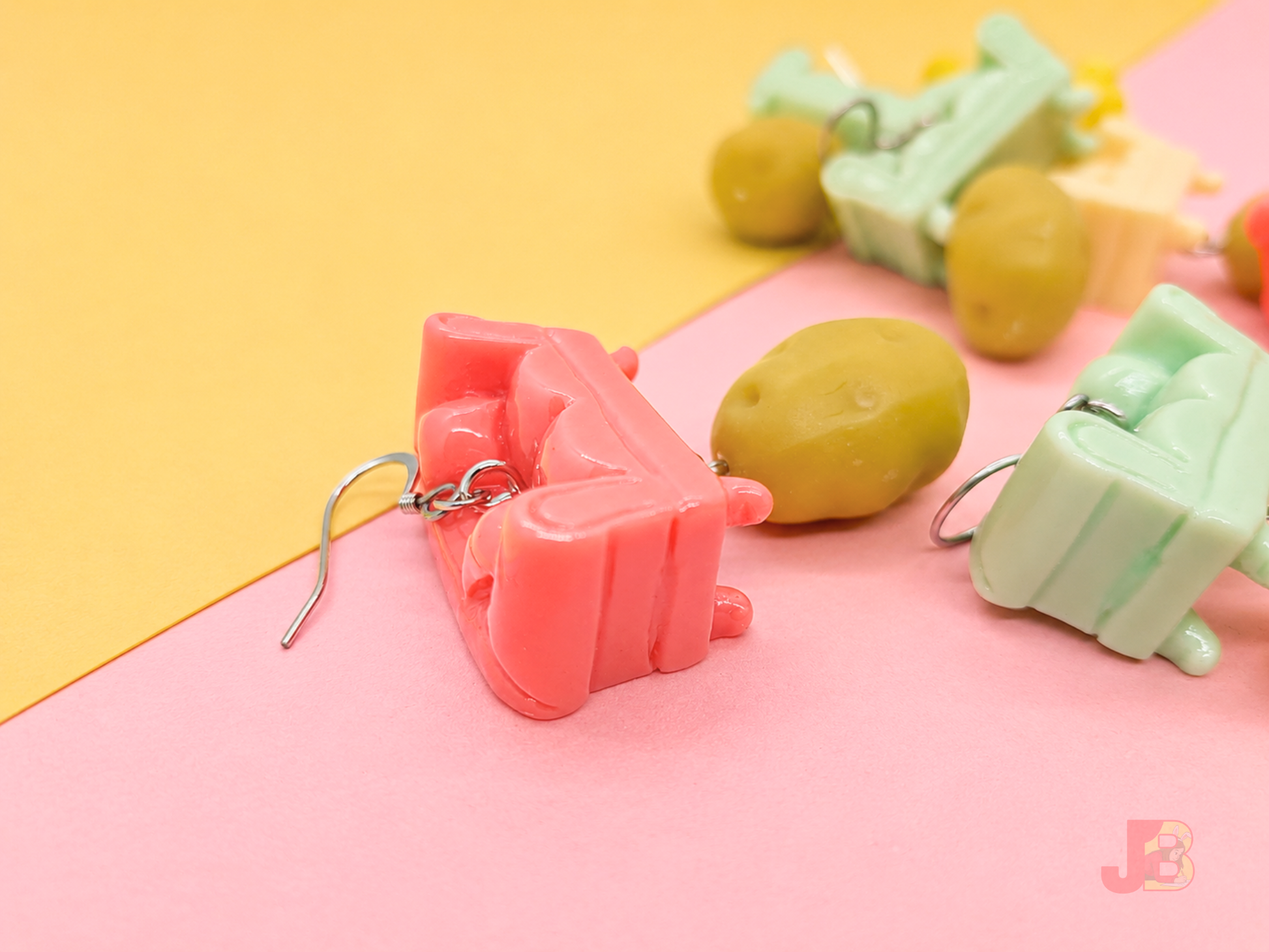 Side profile of these Couch Potato earrings showing the resin glossy finish and details.
