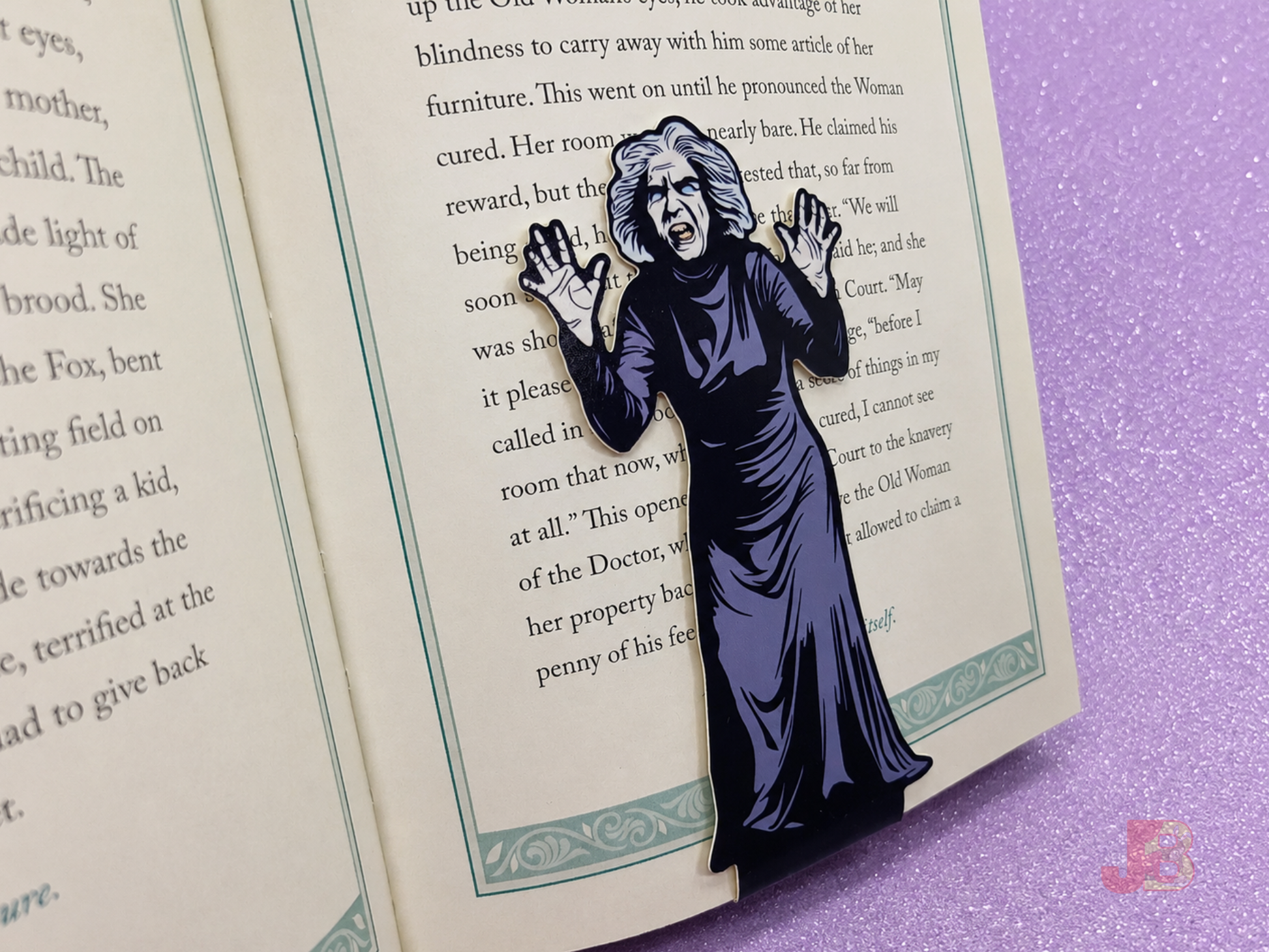 A House on Haunted Hill magnetic bookmark securely clipped on the pages of a hardcover novel.