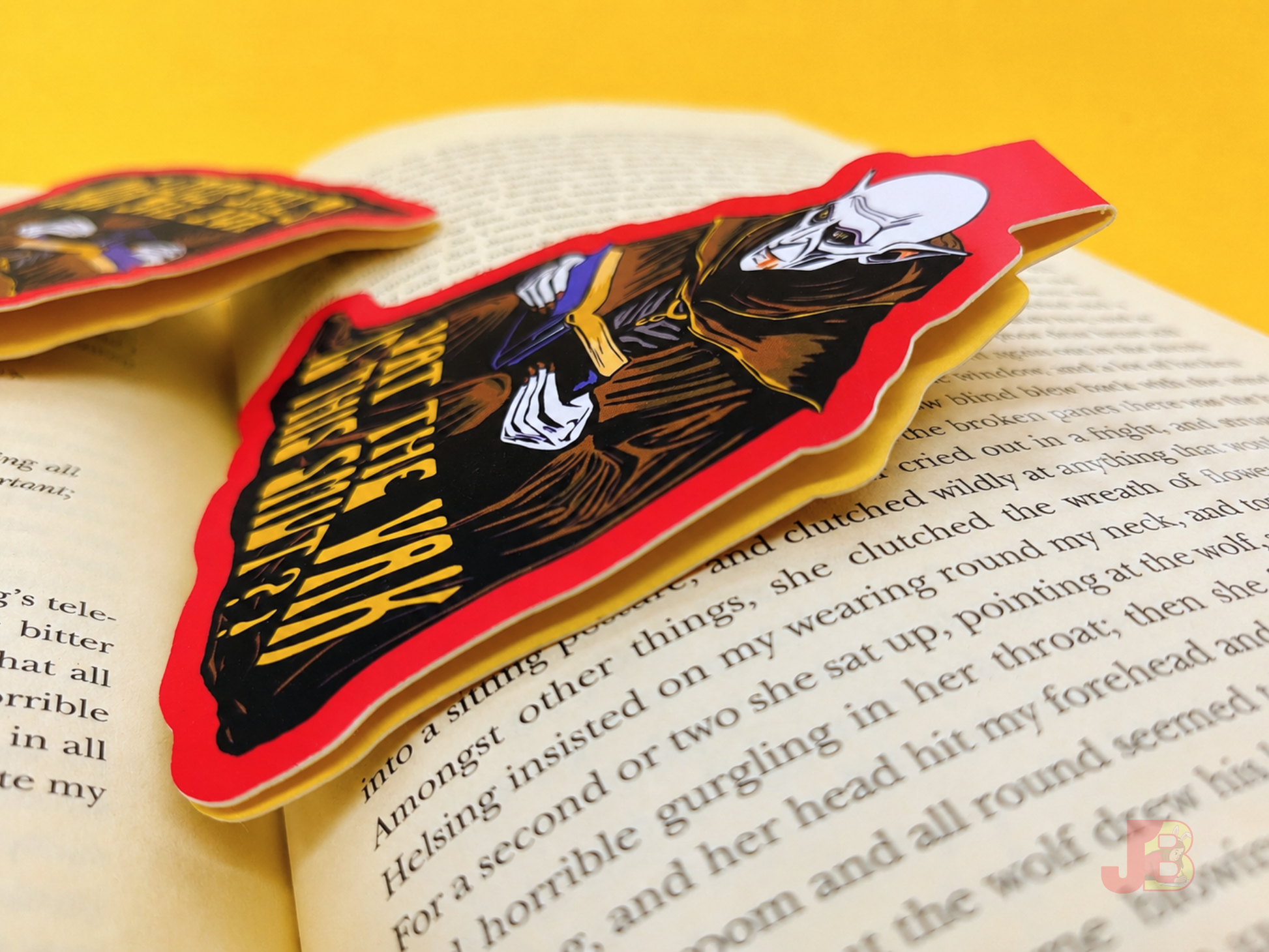 Side view shot of the Nosferatu bookmark resting on an open book.
