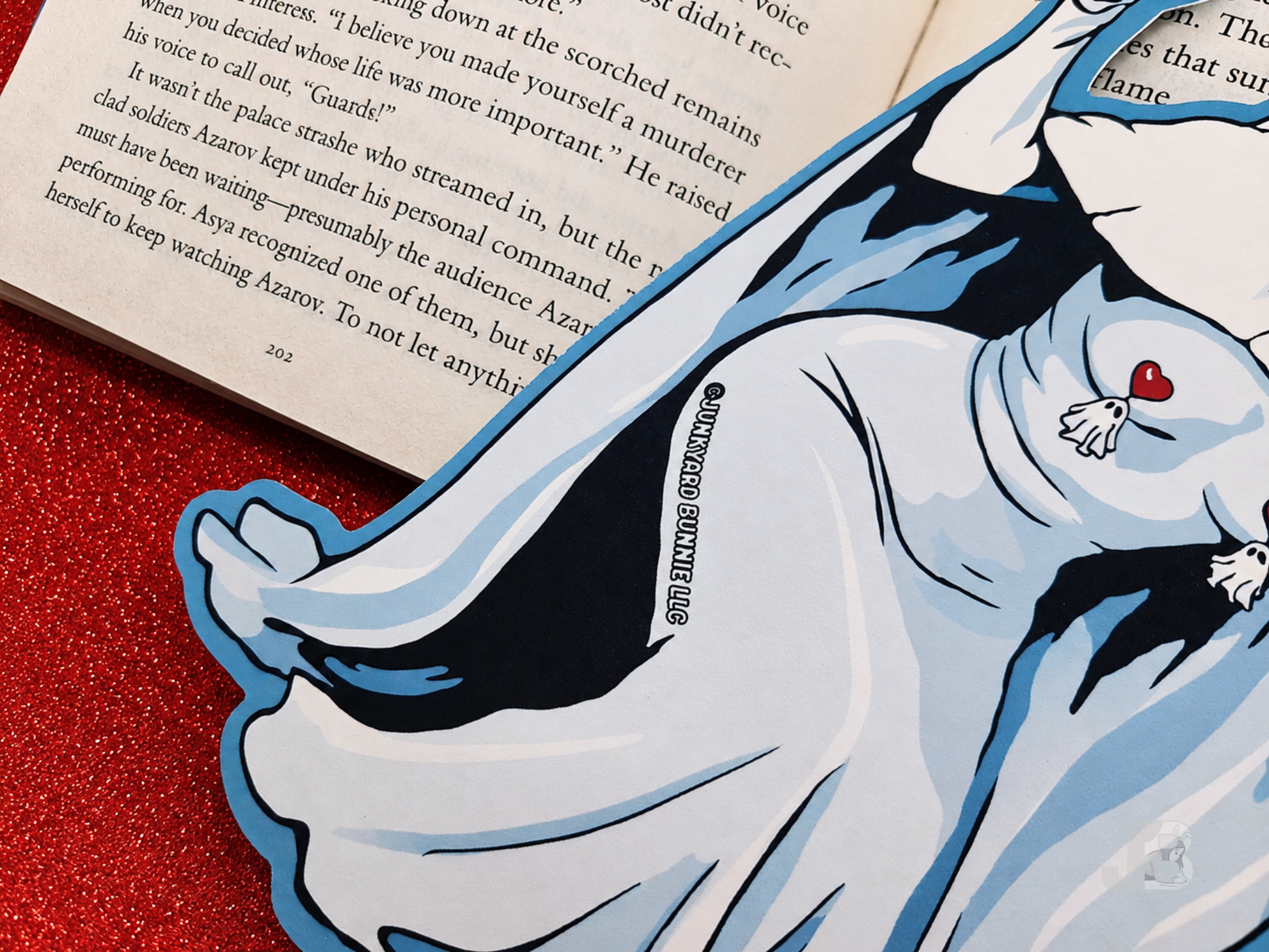 Back side and close-up shot of the Junkyard Bunnie logo on the die-cut, double-sided ghost bookmark.