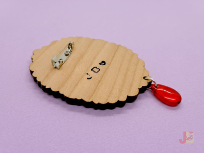 The back of the Vampire Pallas Cat wooden brooch featuring a secured pin-backing that has been screwed on for durability.