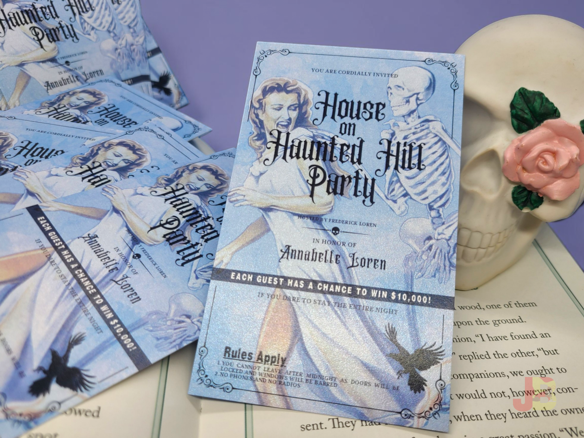 House on Haunted Hill invitation bookmarks resting on top of a novel, showcasing the authentic mid-century spooky typography and vintage party details.