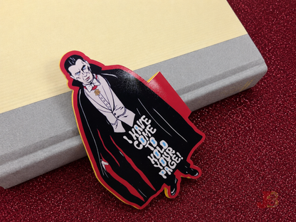 The Dracula magnetic bookmark resting on a closed hardcover novel.