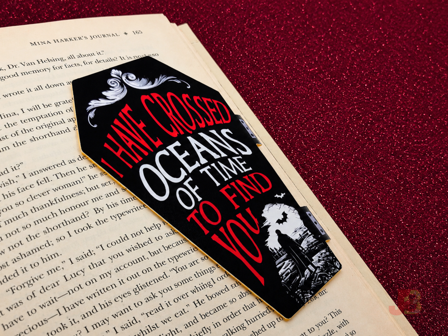 Front of the Dracula 'Oceans of Time' magnetic bookmark securely clipped to a book's page.