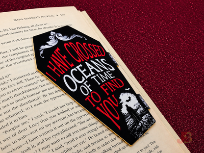 Front of the Dracula 'Oceans of Time' magnetic bookmark securely clipped to a book's page.