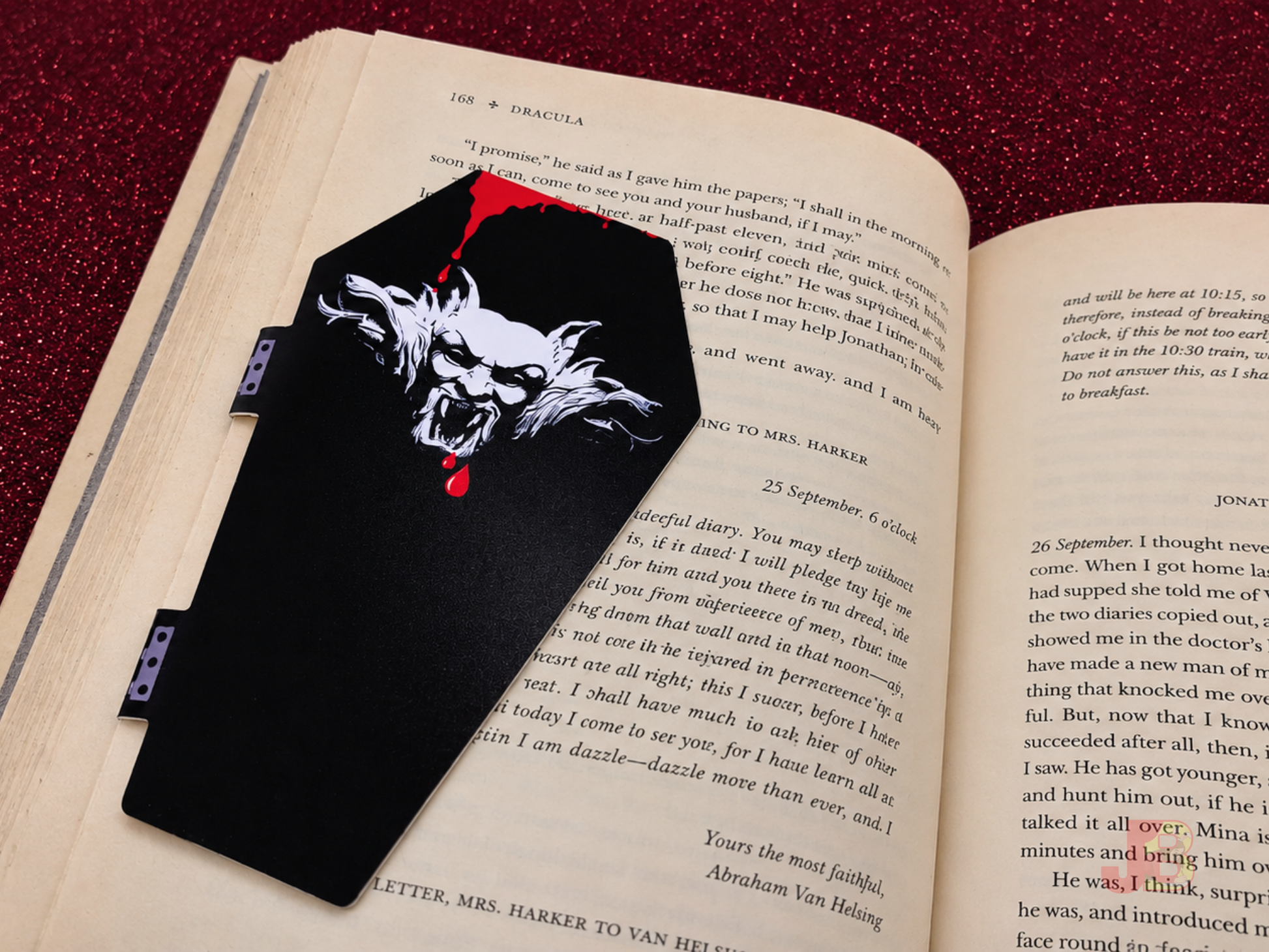 Back of the Dracula 'Oceans of Time' magnetic bookmark securely clipped to a book's page.