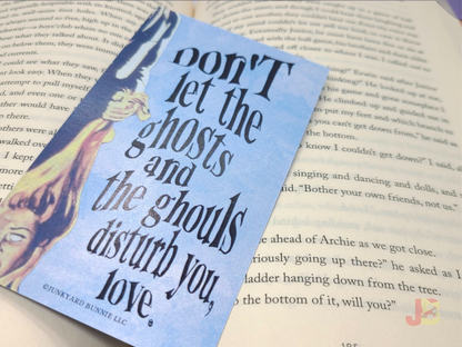 The reverse side of the House on Haunted Hill invitation bookmark. The words say, "Don't let the ghosts and the ghouls disturb you, love."